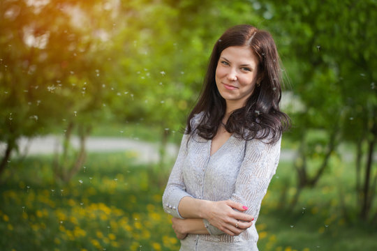 portrait of a beautiful brunette  in a park in spring
