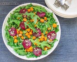 salad with roasted pumpkin, beets, arugula and sunflower seeds