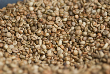Green coffee beans in a pan