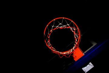 Basketball hoop on  black background with light effect © torsak
