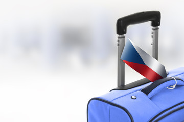 Destination Czech Republic. Blue suitcase with flag.