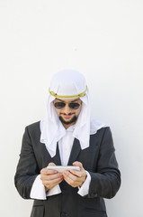 Arab man touching smartphone