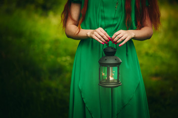 Woman holding lantern with candle