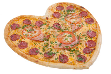 pizza in the shape of a heart with tomatoes, ham and salami spri