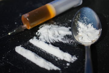 Lines of cocaine, syringe, spoon
