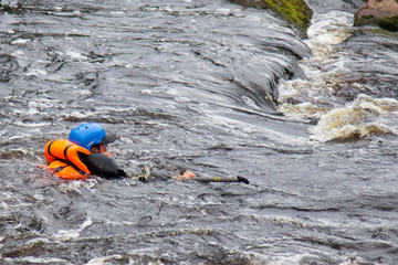 people in life jackets drowning in a turbulent river