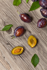 Ripe Plums in wooden box on wooden table