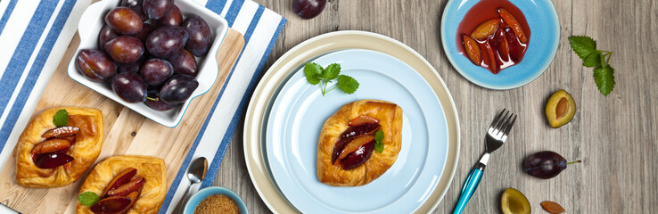 Plums pastries. Panoramic image. Selective focus.