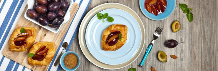 Plums pastries. Panoramic image. Selective focus.