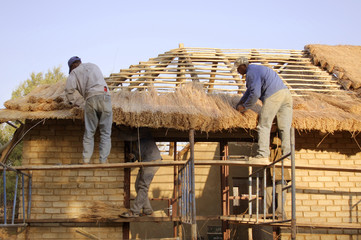 Thatchers laying a grass roof