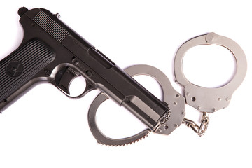 police handcuffs with a gun isolated on a white background