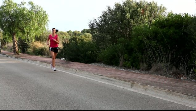 Caucasian woman practicing jogging in the park