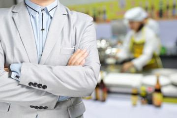 Business Man standing against the Background of Kitchen