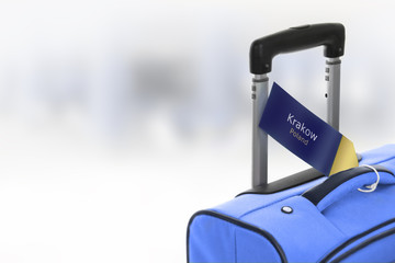 Fototapeta Krakow, Poland. Blue suitcase with label at airport. obraz