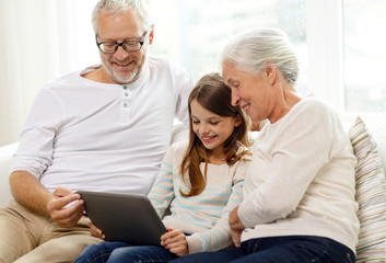 smiling family with tablet pc at home