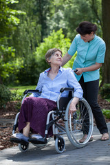 Fototapeta premium Disabled senior woman and nurse in park