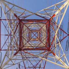 High power transmission towers against blue sky.