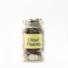 Isolated coins in jar with crowd funding label - financial conce - 70327217