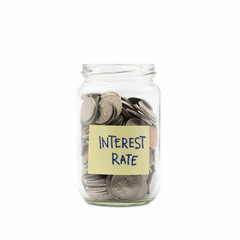 Isolated coins in jar with interest rate label