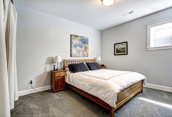Bedroom in grey tones with wooden bed