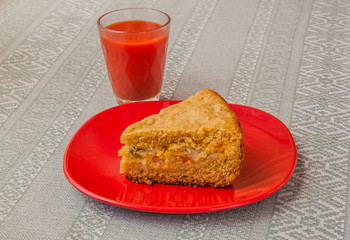 Portion of oat flour cake and glass of tomato juice