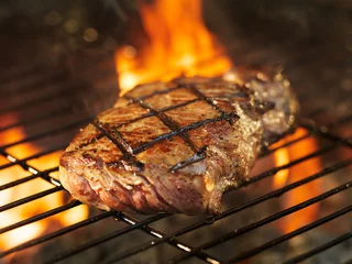 Printed kitchen splashbacks Grill / Barbecue beef steak cooking over flaming grill