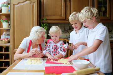 Grandmother with grandkids cooking in the kitchen