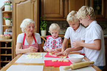 Grandmother with grandkids cooking in the kitchen