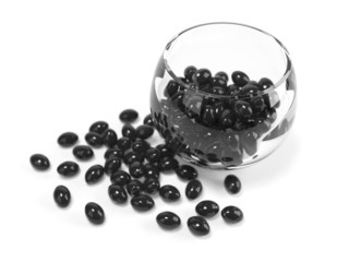 Black  fish oil capsules in glass bowl with cllipping path