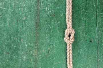 Marine knot on color wooden background