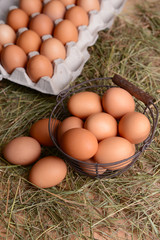Eggs in wicker basket on table close-up