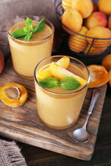 Apricot dessert in glasses on table close-up