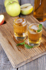 Still life with tasty apple cider in barrel and fresh apples