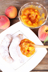 tasty peach jam with fresh peaches and croissants