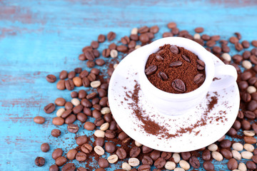 Coffee beans in white ceramic cup with saucer