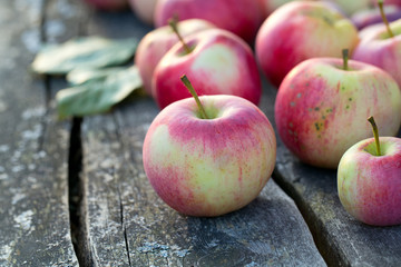 fresh red apples on wooden surface