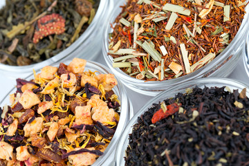 assortment of dry tea in glass bowls