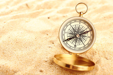 Compass on sand close-up