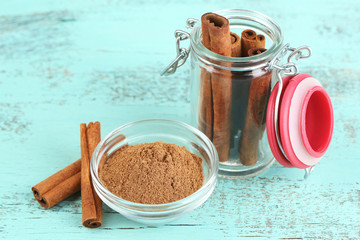 Cinnamon bark and cinnamon powder on wooden table