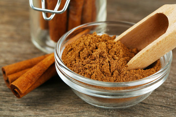 Cinnamon bark and cinnamon powder on wooden table