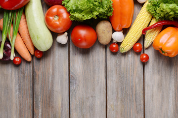 Fresh organic vegetables on wooden background
