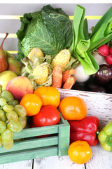 Vegetables in wooden boxes on white wooden box background