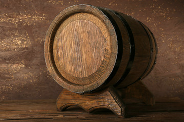 Barrel on wooden table on wooden wall background