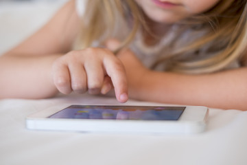 Cute Little girl using mobile phone at home © ldprod
