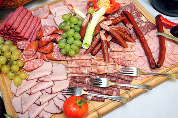 Smoked meat and sausage on a wooden board