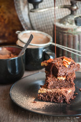 Chocolate pecan brownies with chocolate sauce, selective focus