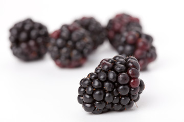 Sweet ripe blackberries isolated on white background.