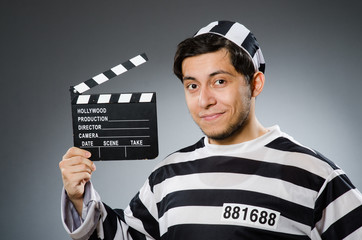Inmate with movie clapper board