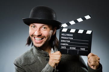 Man with movie clapperboard and hat