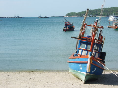 Thai fishing wooden boat at the beach in Thailand.